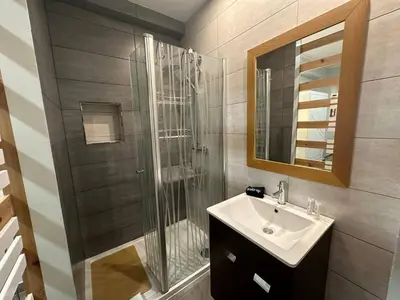a bathroom with a sink and a glass shower at Carteia Mar by FHR frente Mar & piscina in Quarteira