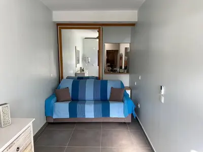 a bedroom with a bed with blue and white stripes at Carteia Mar by FHR frente Mar & piscina in Quarteira