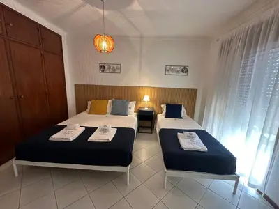 a bedroom with two beds and a lamp at Âncora by FHR a 600m da praia in Quarteira