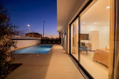 a view from the balcony of a house with a swimming pool at Sirius House in Guia