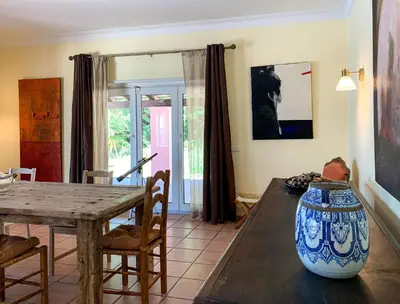 a dining room with a table and a large vase at Villa Monte dos Agostos by Boaz Rentals in Santa Bárbara de Nexe