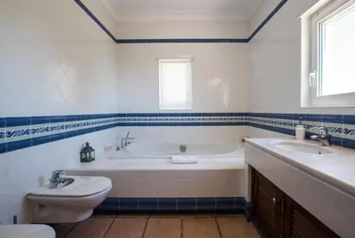 a bathroom with a tub and a toilet and a sink at Villa Monte dos Agostos by Boaz Rentals in Santa Bárbara de Nexe