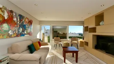 a living room with a couch and a tv at MouraSuites CD 601 - Cleverdetails in Vilamoura