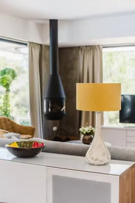 a lamp sitting on top of a table in a living room at Casa da Alegria, Vale do Lobo in Almancil