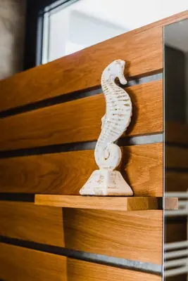 a statue of a snake sitting on a wooden drawer at Casa da Alegria, Vale do Lobo in Almancil