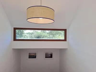 a room with a window and a pendant light at Balaia Praia in Albufeira