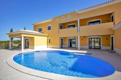 a large swimming pool in front of a house at Quinta do Sol in Guia