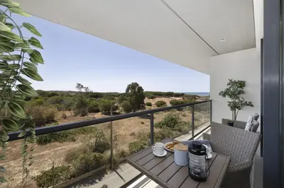 a view from the balcony of a house with a table at Sol e Mar in Quarteira