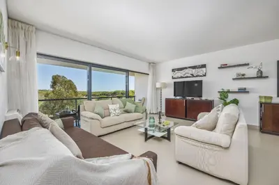 a living room with two couches and a tv at Vista Mar in Quarteira