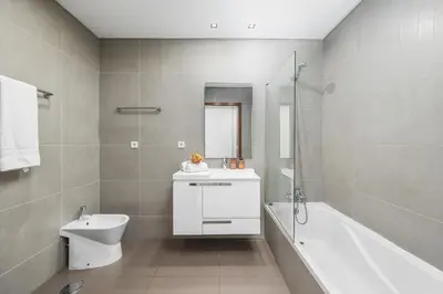 a bathroom with a sink and a toilet and a bath tub at Vista Mar in Quarteira