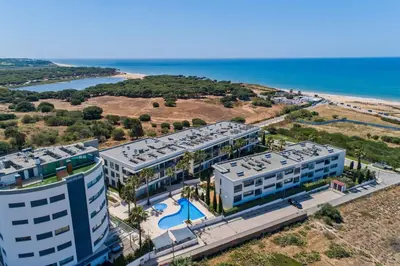 an aerial view of a building and the beach at Vista Mar in Quarteira