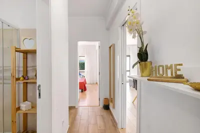 a living room with white walls and a white hallway at Apartment Zeza in Albufeira