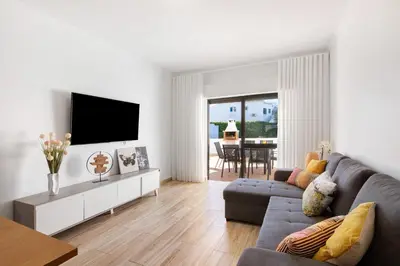 a living room with a couch and a tv at Apartment Zeza in Albufeira