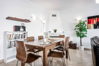 a dining room with a wooden table and chairs at Villa Felizalgarve in Albufeira