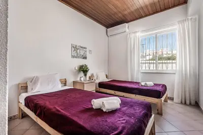 a kitchen with white cabinets and a dishwasher at Villa Oahu in Albufeira