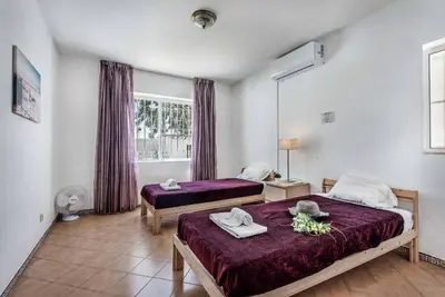 a bedroom with two beds and a window at Villa Rum Cay in Albufeira