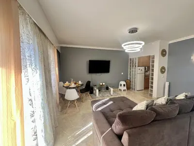 a living room with a couch and a table at Albufeira Town Apartment With Pool by Homing in Albufeira