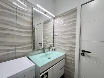 a bathroom with a sink and a mirror at Albufeira Town Apartment With Pool by Homing in Albufeira