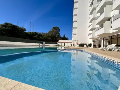 a swimming pool in front of a building at Albufeira Town Apartment With Pool by Homing in Albufeira
