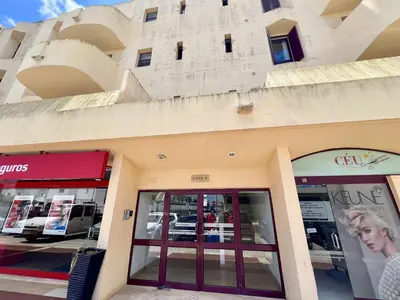 a facade of a store with glass doors at Albufeira Central 9 by Homing in Albufeira