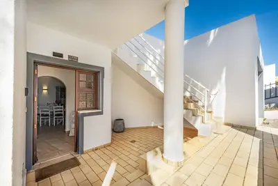a white house with a staircase and a room at Villa Jasmin Marina in Albufeira