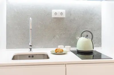 a kitchen sink with a tea kettle and a plate of food at BLUE - Vilamoura in Vilamoura