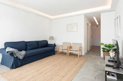 a living room with a blue couch and a tv at BLUE - Vilamoura in Vilamoura
