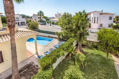 an aerial view of a villa with a swimming pool and palm trees at Villa Pardal in Albufeira