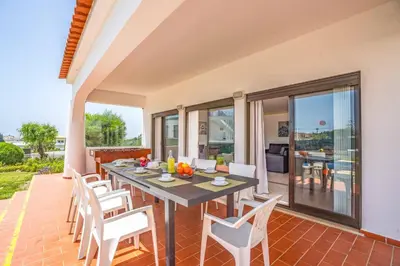 a dining room with a table and chairs on a patio at Villa Palawan in Galé
