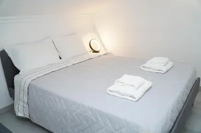 a bedroom with a bed with towels on it at Apartment Berardo - Perfect for families in Albufeira