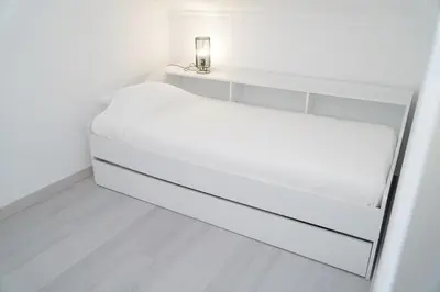 a white bed in a white room at Apartment Berardo - Perfect for families in Albufeira
