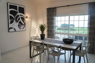 a dining room with a table and chairs and a window at Apartment Berardo - Perfect for families in Albufeira