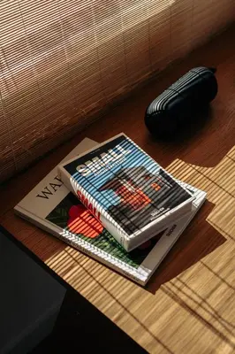 two books sitting on top of a wooden table at Outsite Vilamoura in Quarteira