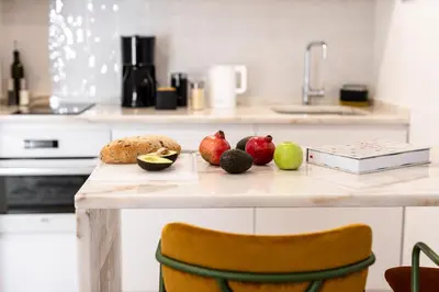 a table with fruits and vegetables on it in a kitchen at Outsite Vilamoura in Quarteira