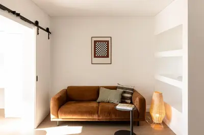 a living room with a brown leather couch at Outsite Vilamoura in Quarteira