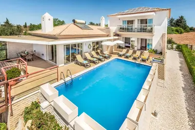 a house with a swimming pool in front of a house at Villa Casa Sol in Albufeira