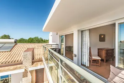 a balcony of a house with a table and a desk at Villa Casa Sol in Albufeira