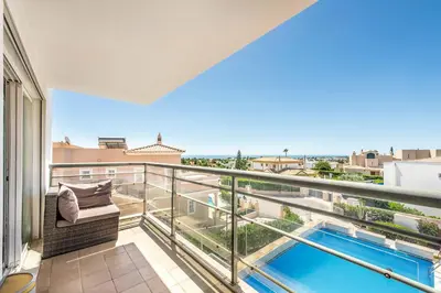 an apartment balcony with a view of a swimming pool at Villa Casa Sol in Albufeira