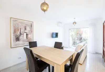 a dining room with a wooden table and chairs at Apartment Nidio - Great Location in Albufeira