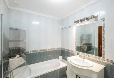 a bathroom with a sink and a mirror and a tub at Apartment Nidio - Great Location in Albufeira