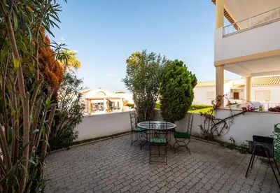 a patio with a table and chairs in a backyard at Apartment Nidio - Great Location in Albufeira
