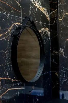 a mirror with a black strap on a counter at Crystal bay in Albufeira