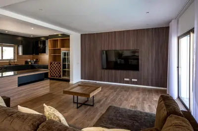 a living room with a couch and a tv on a wall at Crystal bay in Albufeira