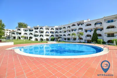 a swimming pool in front of a building at Vale Mangude B by MTPhomes in Albufeira