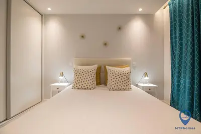 a bedroom with a large white bed with two lamps at Vale Mangude B by MTPhomes in Albufeira