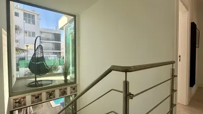 a staircase with a large window in a building at Lua by Check-in Portugal in Albufeira