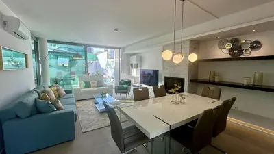 a dining room and living room with a table and chairs at Lua by Check-in Portugal in Albufeira