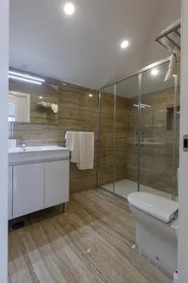 a bathroom with a shower and a toilet and a sink at Solar Mendonca in Faro