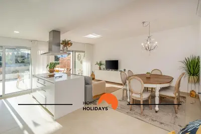 a kitchen and living room with a table and a dining room at #264 Green Apartments C04 by Home Holidays in Albufeira