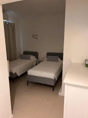 a room with two beds in a room at Vivenda Fairways in Quarteira